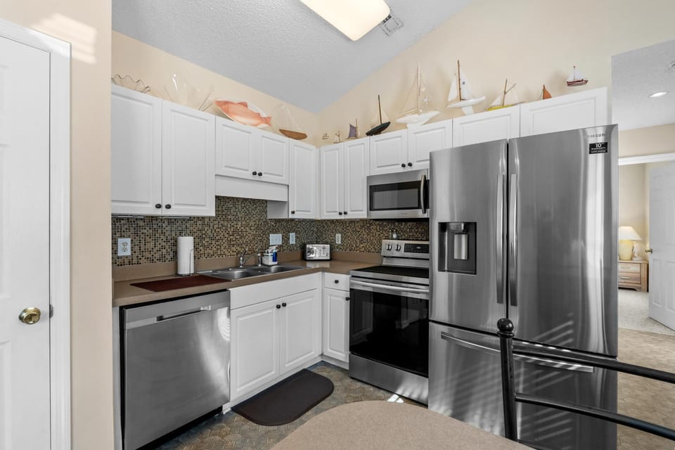 Bright, modern kitchen with stainless steel appliances and skylight