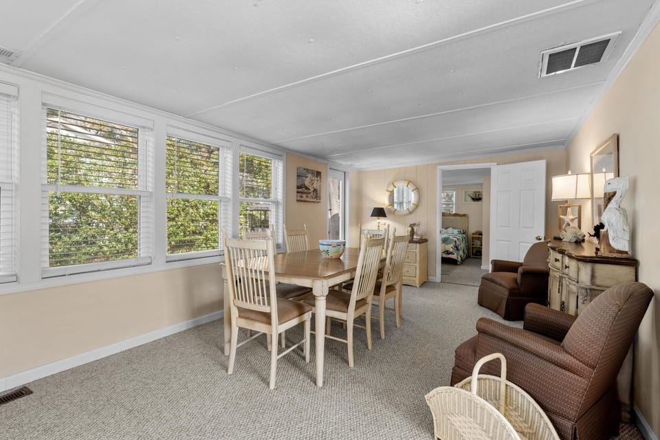 Bright and airy dining room with garden views and cozy seating
