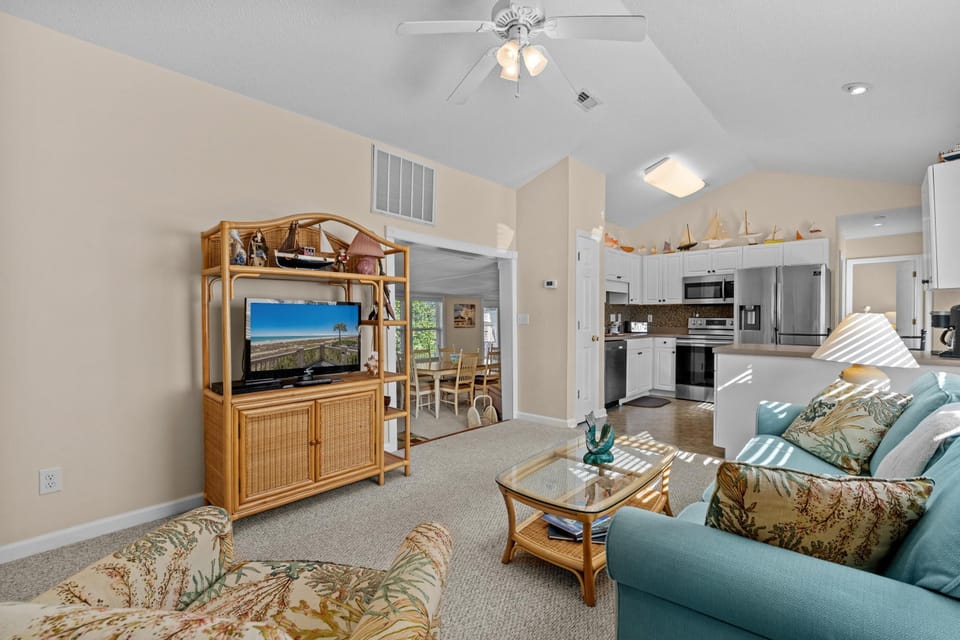 Bright and airy living room with cozy seating and entertainment center