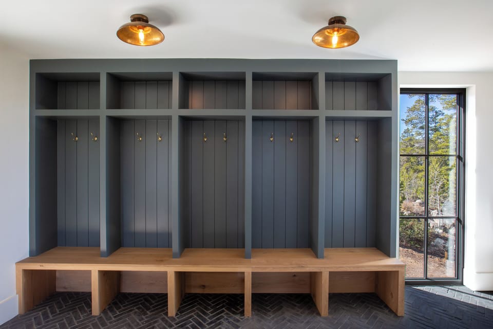 The mudroom greets you with our custom 5-bay bench and shelving built-ins