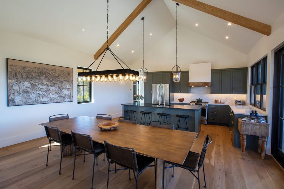 Plenty of seating for everyone between the dining table, indoor and outdoor bars