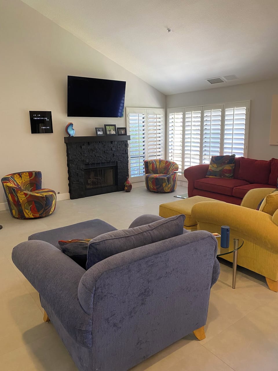 Vaulted ceiling living room with fireplace and 65 inch smart tv