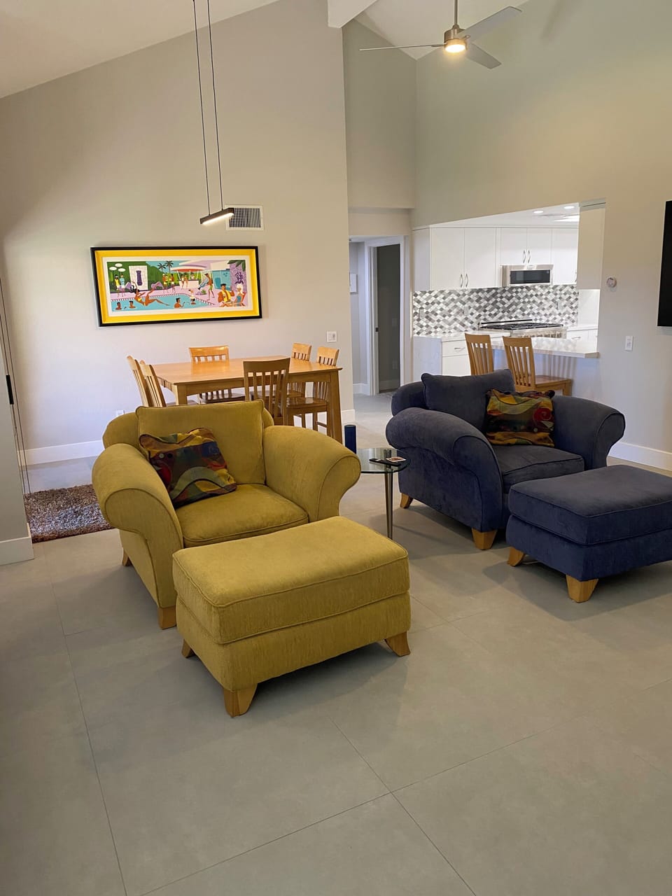 dining room with table and 8 chairs next to living room and kitchen