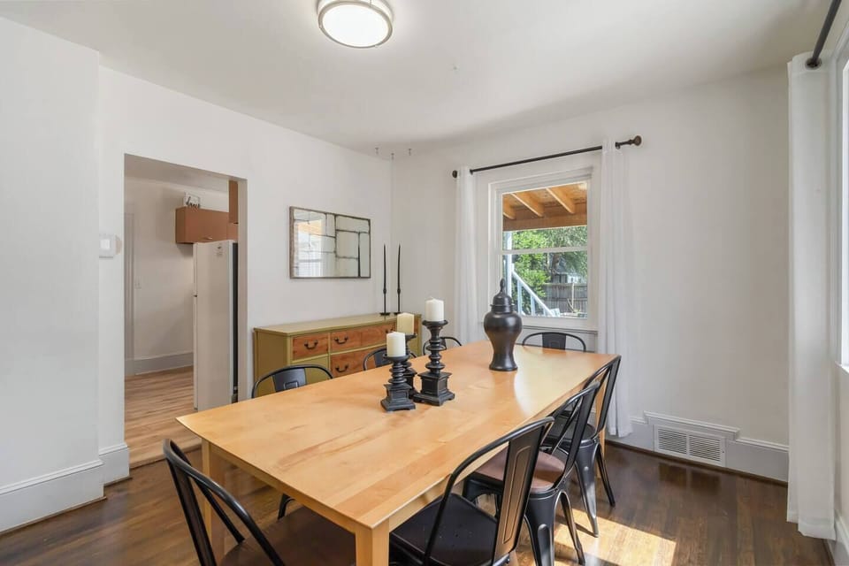 Our main-floor dining area features a warm wooden table perfect for family meals, casual gatherings, or enjoying a cozy breakfast together.