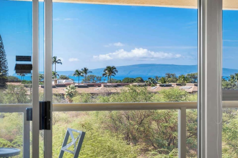 Step out onto your private lanai and soak in the view of lush tropical nature, offering a peaceful and beautiful backdrop for your stay.