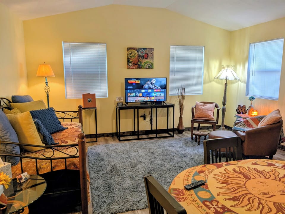 Living room with daybed, television, mini split