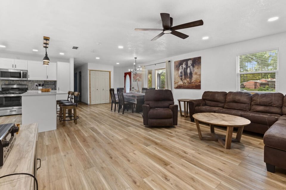 Open-concept living space with cozy seating, smart TV, and natural light — perfect for relaxing or entertaining.