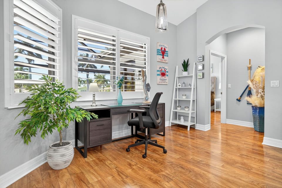 Cozy work area in the breakfast nook with a view of the pool — an ideal spot for catching up on emails or enjoying a quiet moment.