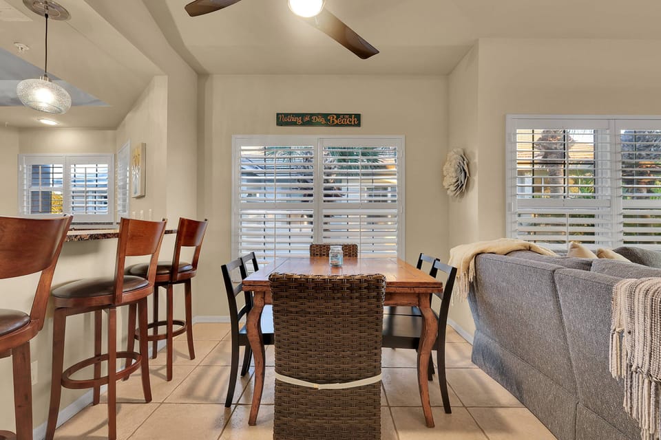 A table with seating for six is in the dining area between the living room and kitchen.