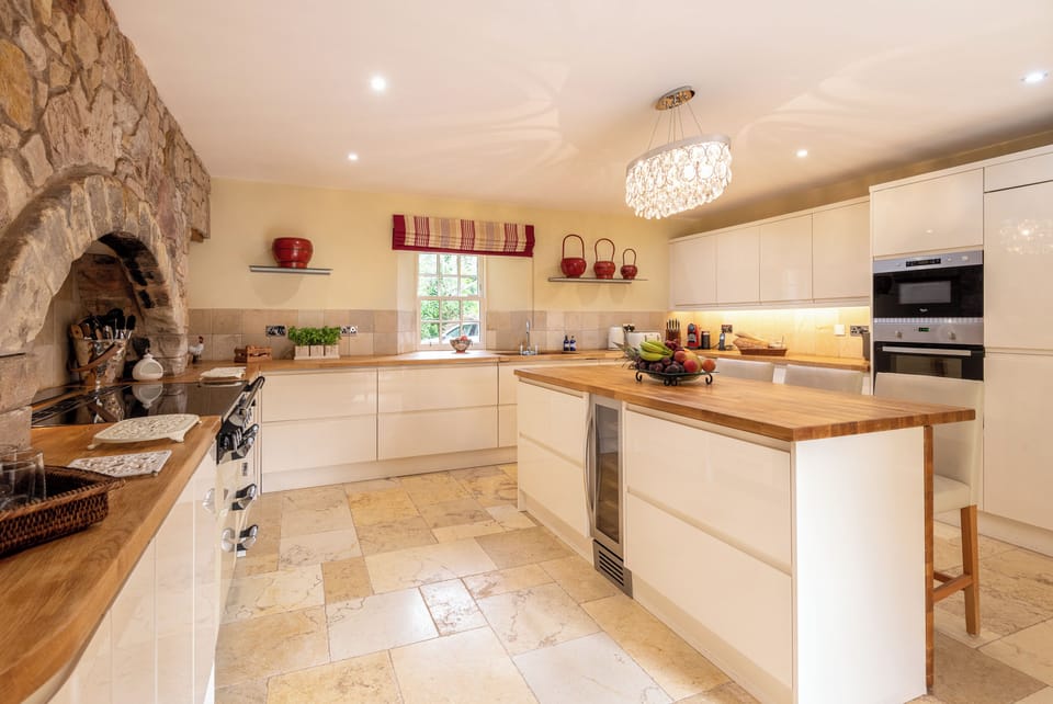 The kitchen with loads of space, ample crockery and cutlery and other utensils 
