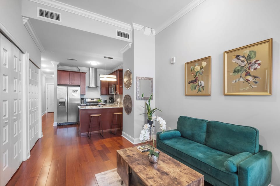 Living and kitchen area with open concept layout maximizing space in this efficient studio design.