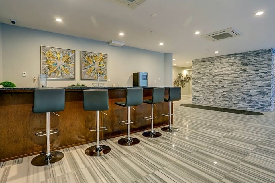Elegant building lobby with 24/7 concierge service and complimentary coffee and tea station.