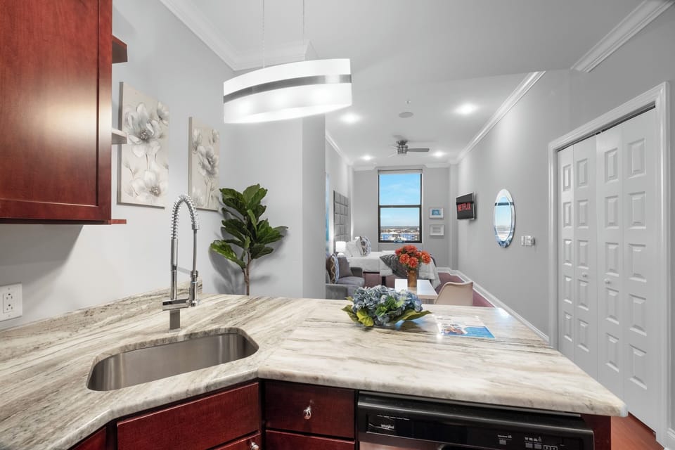 Kitchen with granite breakfast bar and island seating offering casual dining space.
