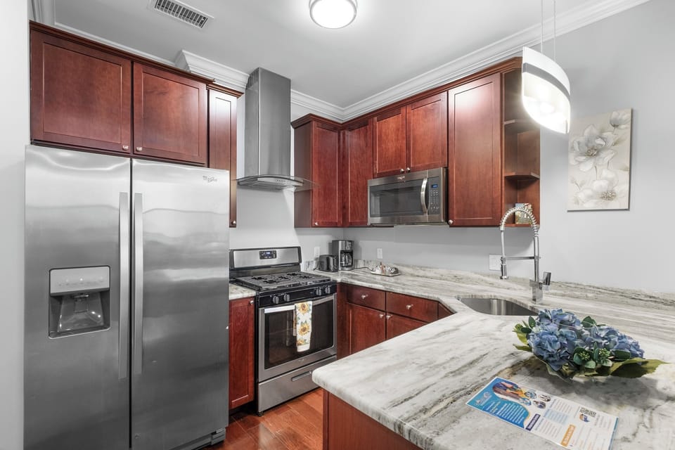 Stylish kitchen with a sleek design, complete with cookware and utensils for your convenience.

