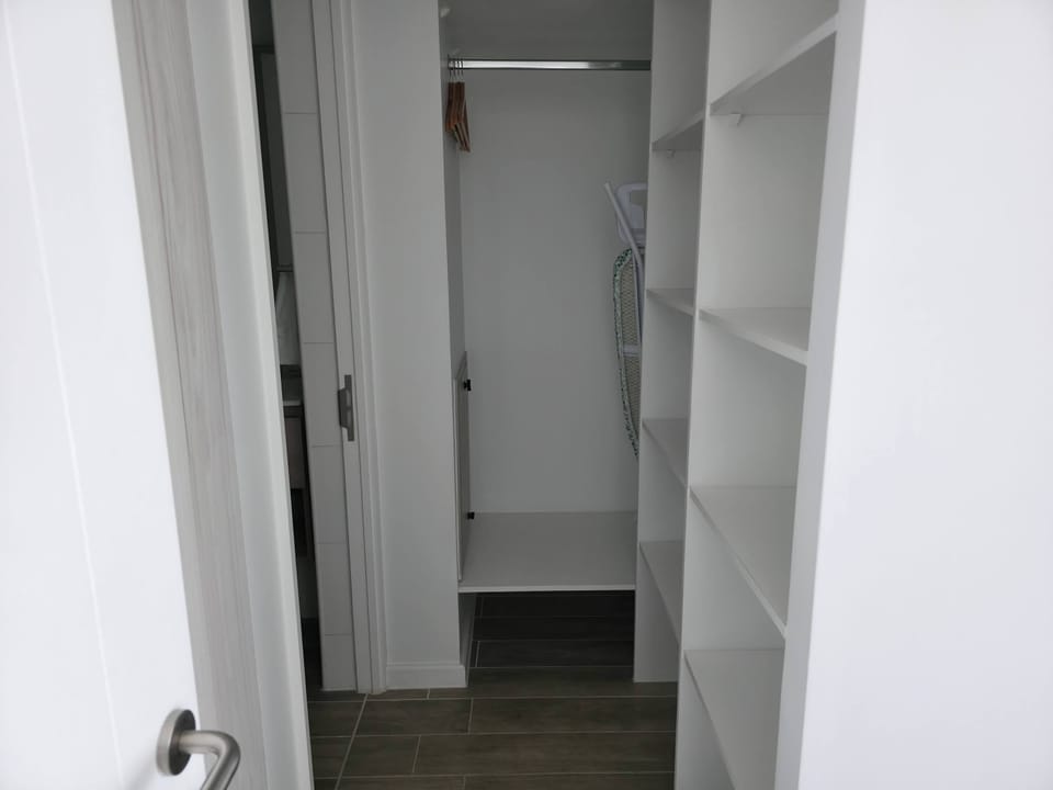 Organize your stay with ample closet space featuring shelves and hanging area, perfect for keeping your belongings tidy.