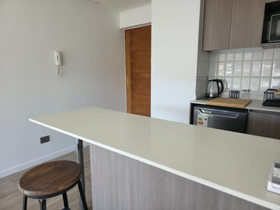 Sleek kitchen with modern appliances and a cozy breakfast bar, perfect for intimate meal preparations.
