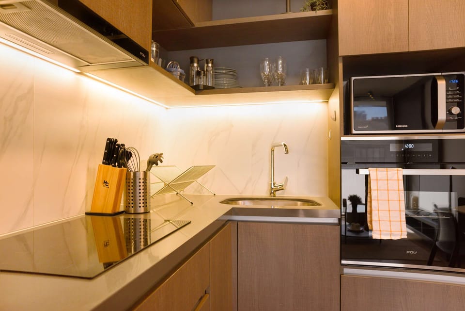 Sleek and modern kitchen with top-notch appliances, perfect for culinary adventures during your stay.
