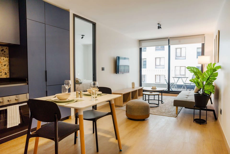 Bright and modern living area with a cozy seating space and a charming balcony view.