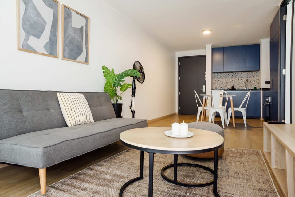 Chic and cozy living space with modern decor and a fully equipped kitchenette, perfect for a relaxing stay.