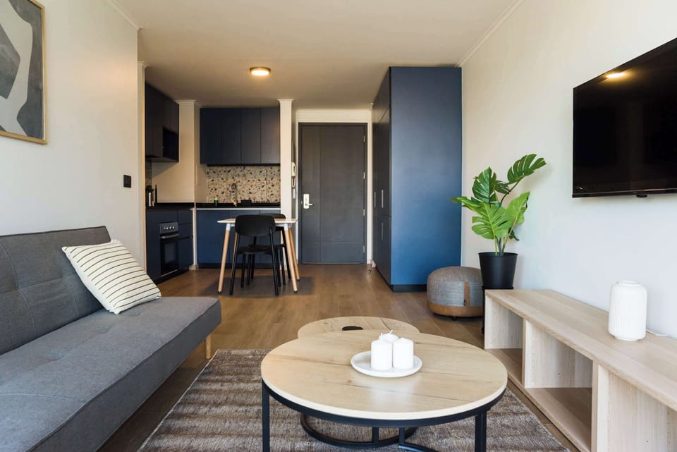 Chic studio with a cozy living area and stylish kitchen, perfect for a comfortable stay in the heart of the city.