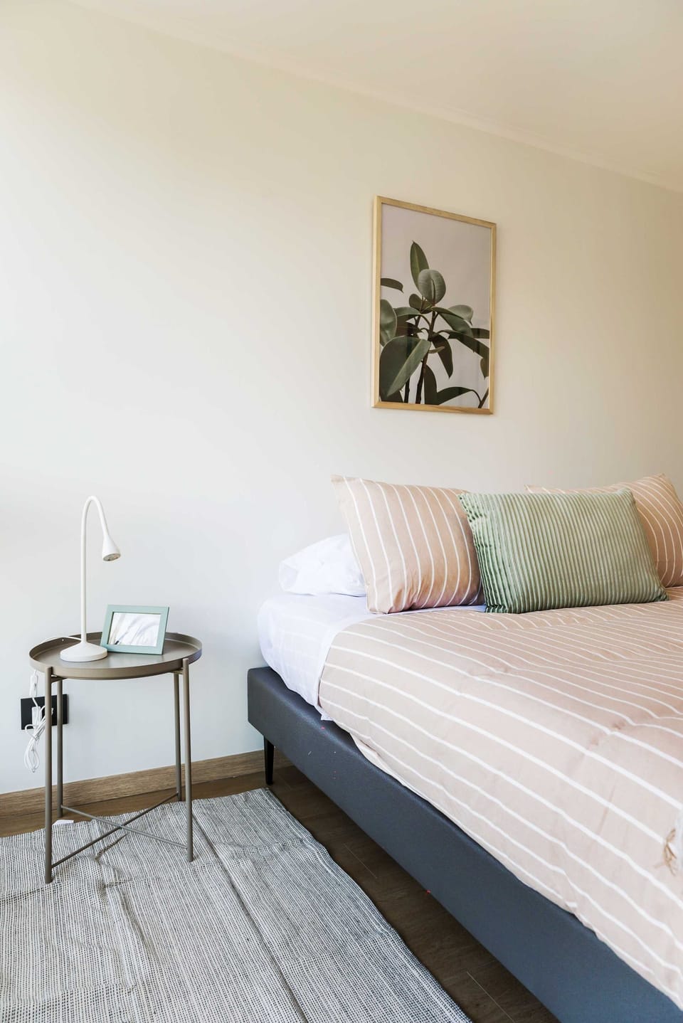 Bright and modern bedroom with stylish decor and cozy bedding, perfect for relaxation.