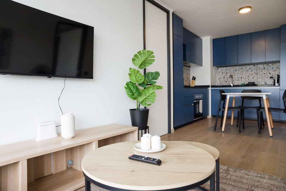Stylish living area with sleek kitchen and dining space, perfect for relaxation and socializing.
