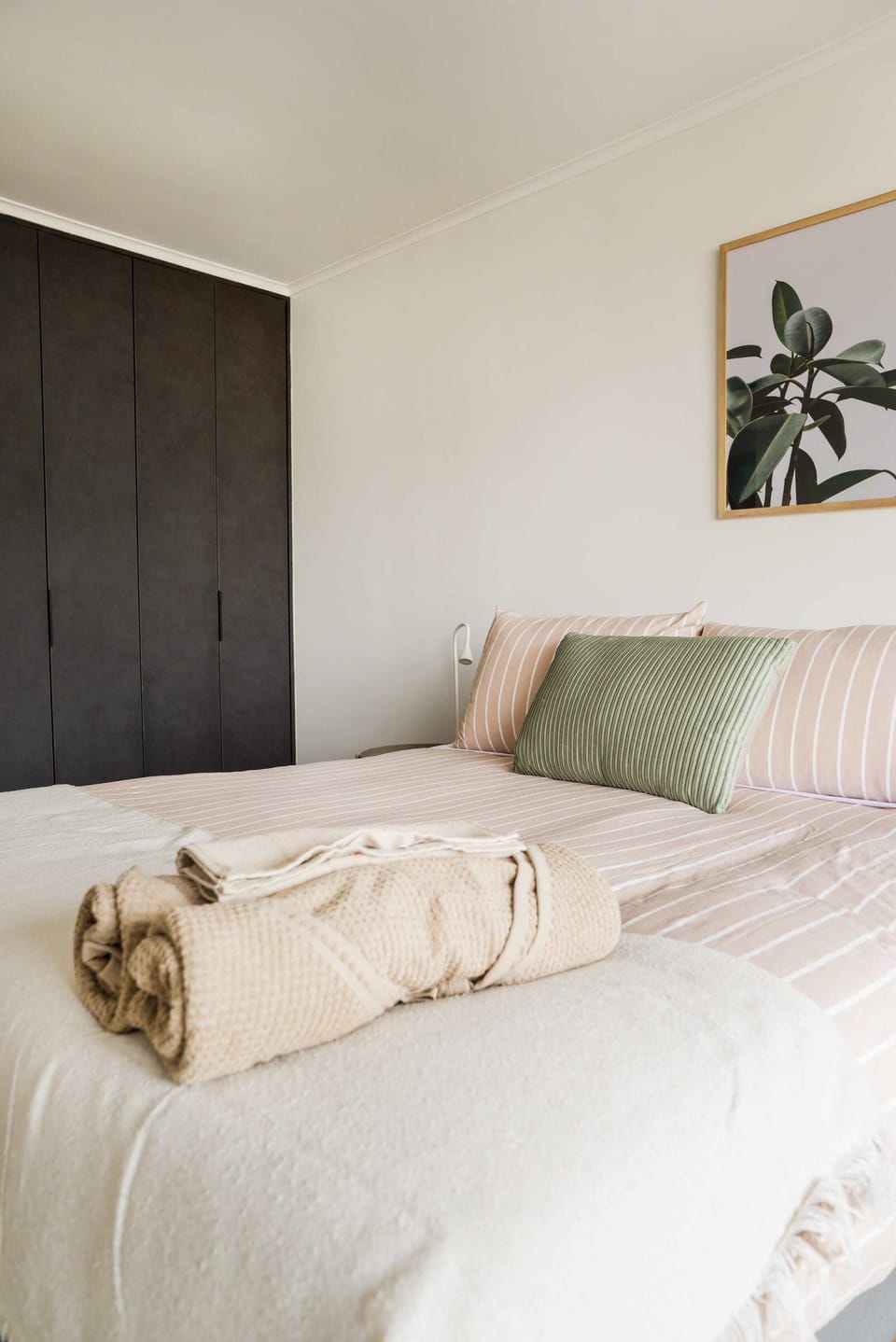 Unwind in this serene bedroom with chic decor and ample storage, perfect for relaxation after city adventures.