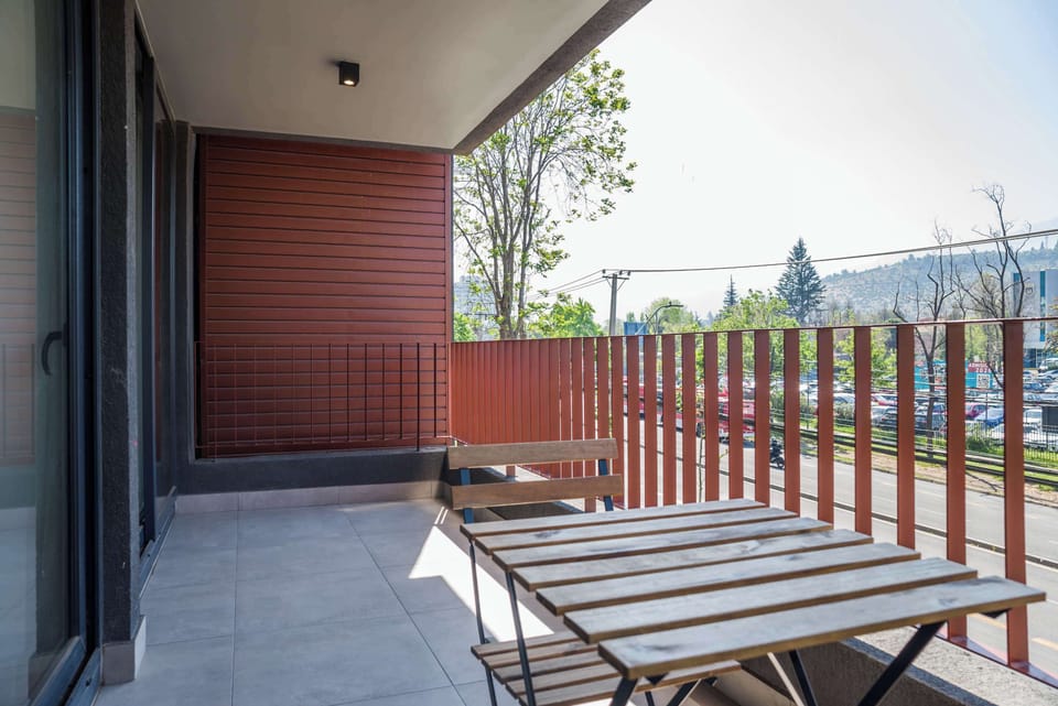 Relax on your private balcony with a scenic view of the hills and vibrant surroundings.