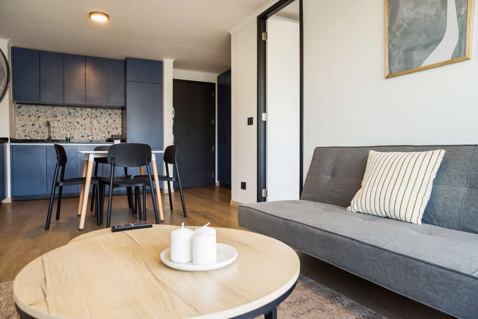 Cozy living space with modern kitchen and dining area, perfect for relaxing after a day exploring the city.