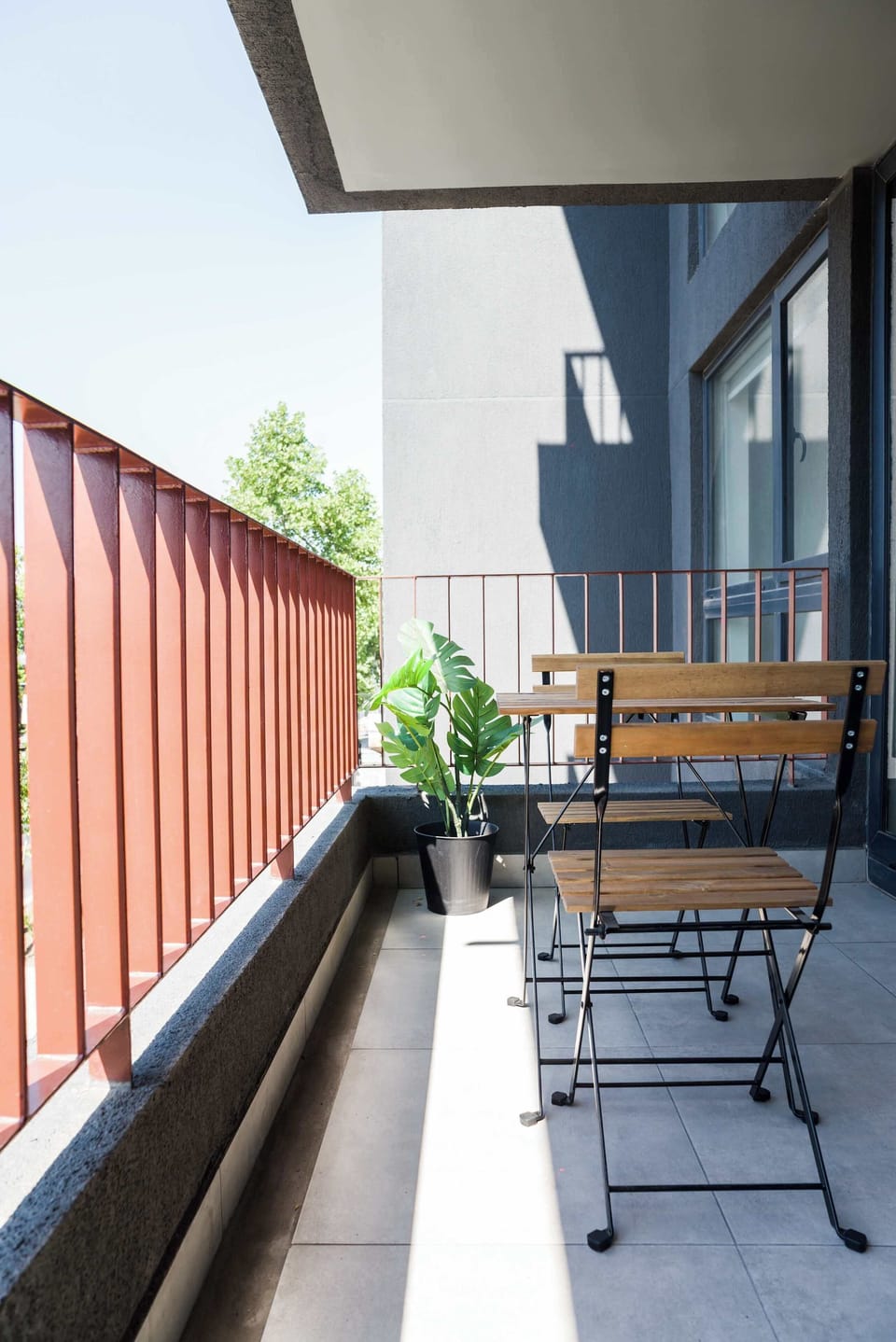 Enjoy your morning coffee on this sunny private balcony with a refreshing view.