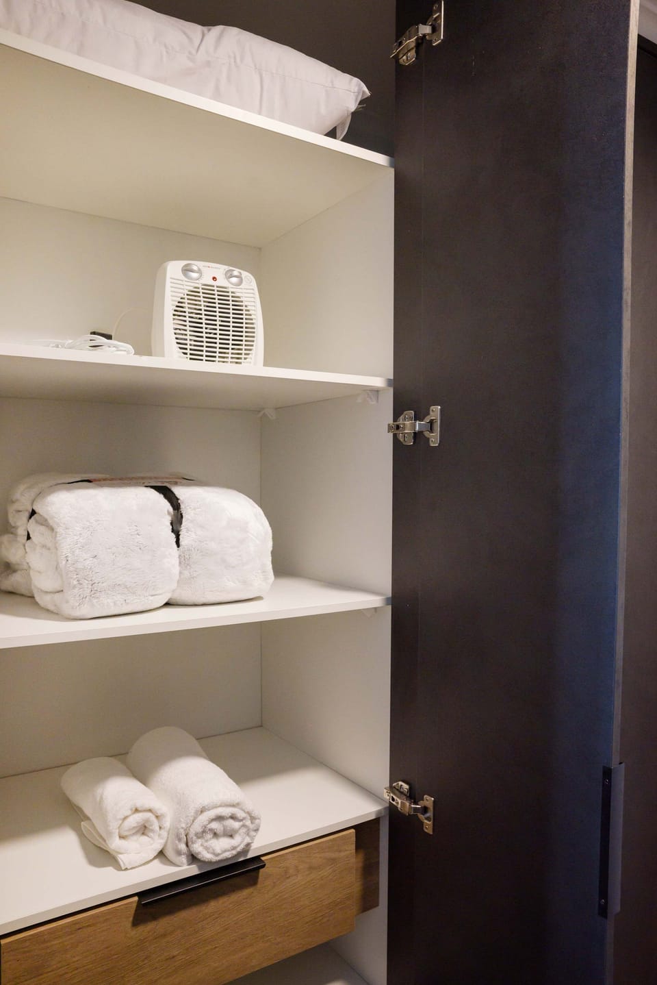 Well-stocked closet with cozy blankets and essentials for a comfortable stay.