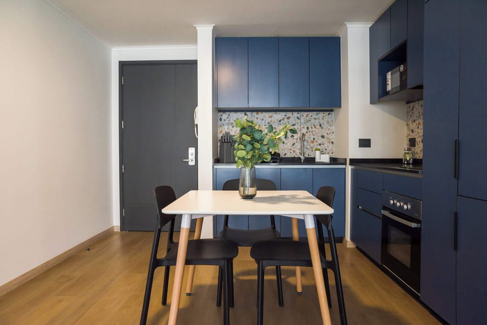 Chic kitchen with blue cabinets and terrazzo accents, ideal for cozy meals and culinary creativity.