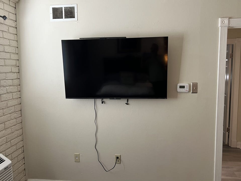 Large wall mounted tv for movie watching or gaming in the comfort of the bedroom