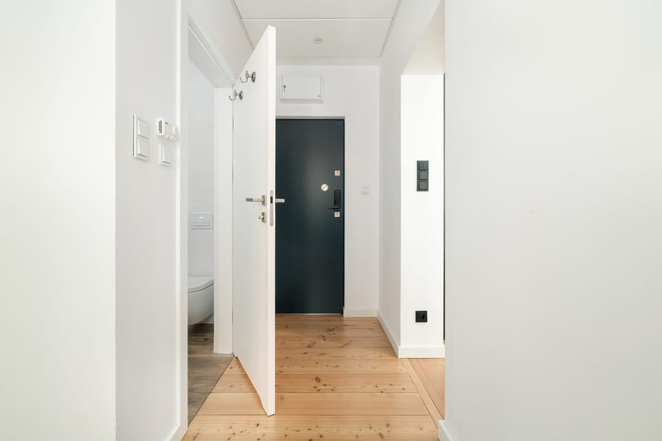 Clean and bright entrance hallway with wooden floors.