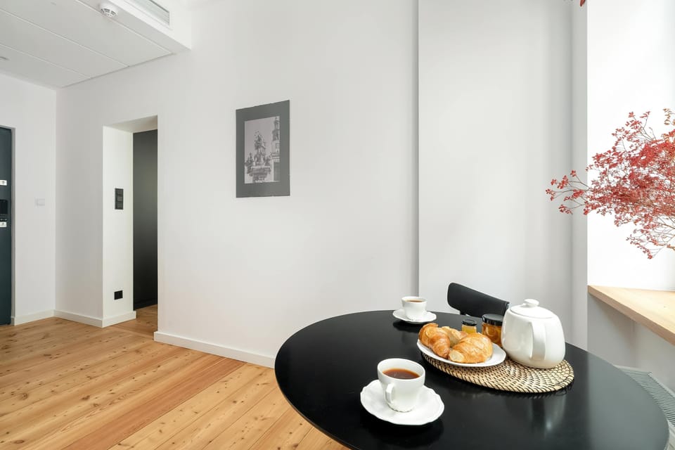 Dining corner with fresh flowers and breakfast setup.