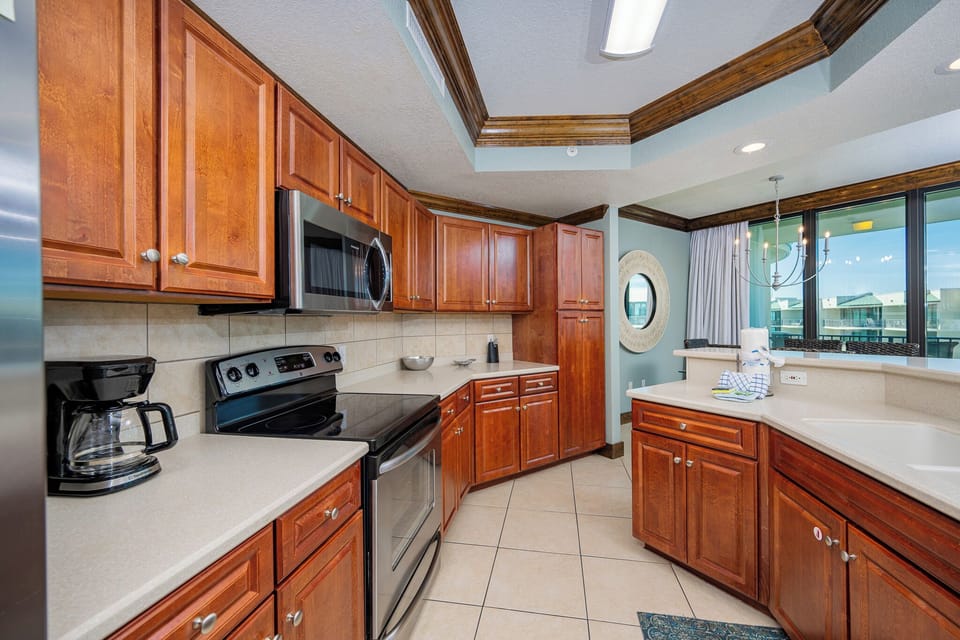 Prepare meals in this kitchen with elegant cabinetry, stainless appliances, and spacious countertops