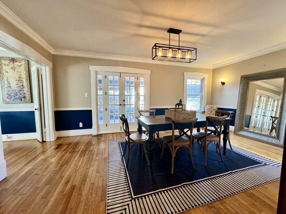 Formal dining room between the kitchen, living room, and spacious side porch.
