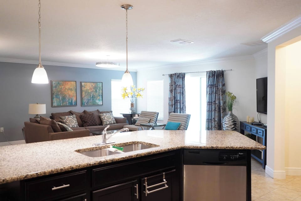 Open-concept living at its best! A spacious kitchen island seamlessly blending with the cozy living area.