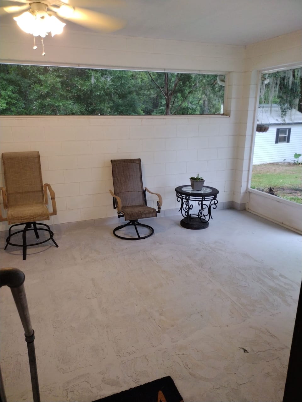 enclosed porch with bug screen, ceilingfan chairs an table to enjoy company 