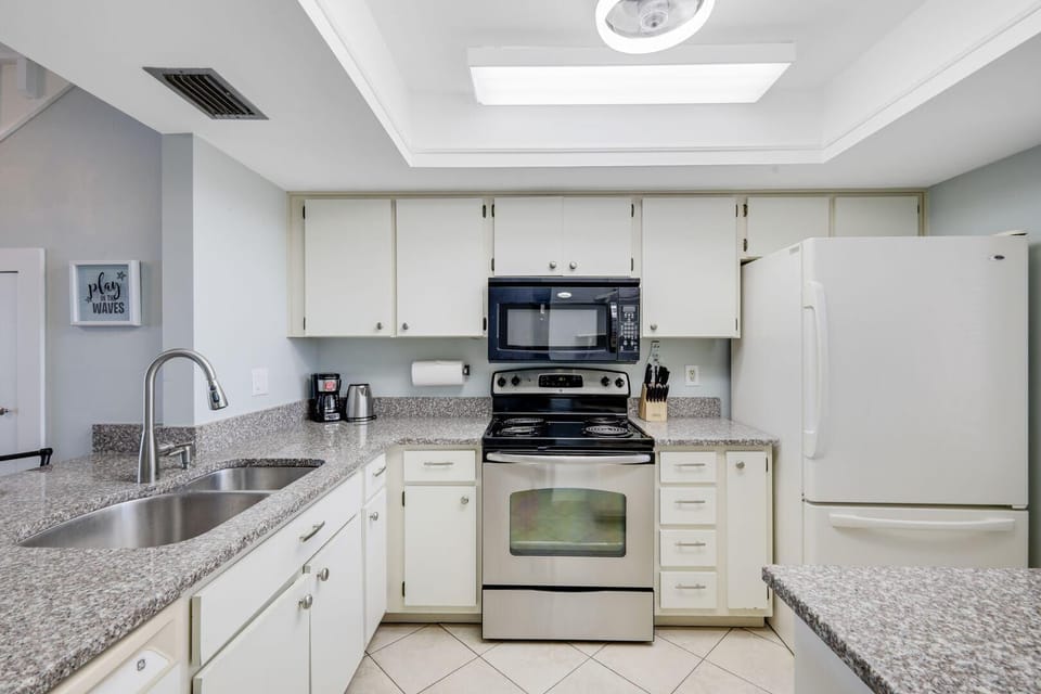 Bright, modern kitchen with granite countertops and stainless appliances