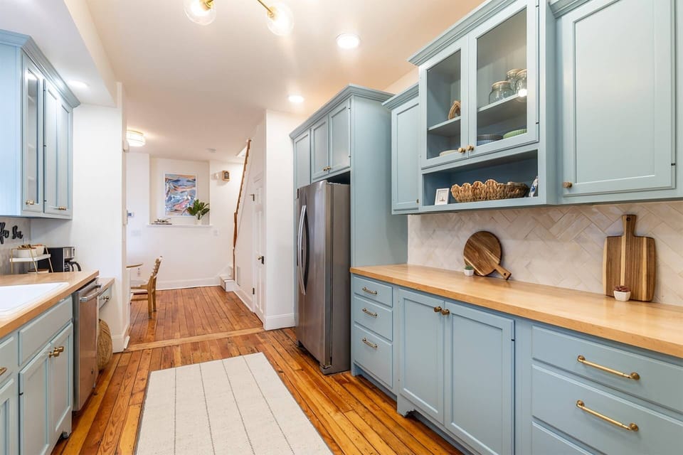 At the end of the kitchen counter, the coffee bar doubles as a cleverly-designed workspace with seating.