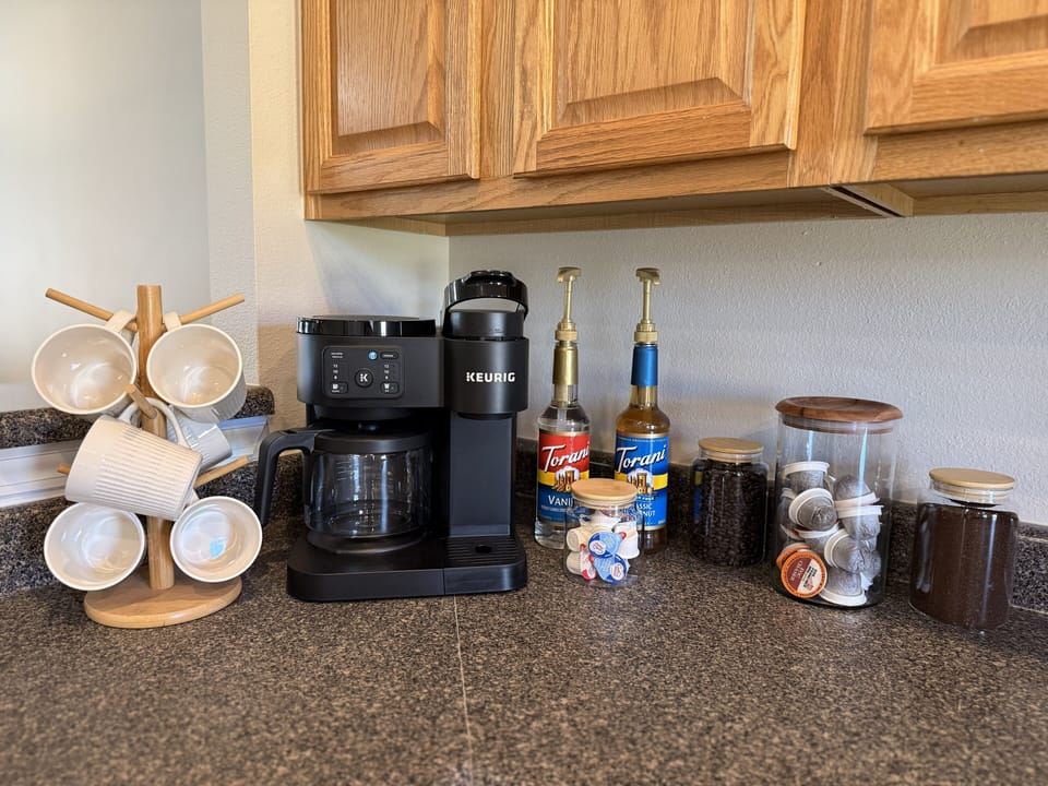 Well-appointed coffee bar w/ground & bean coffee, k-cups, sugar, cream, syrup