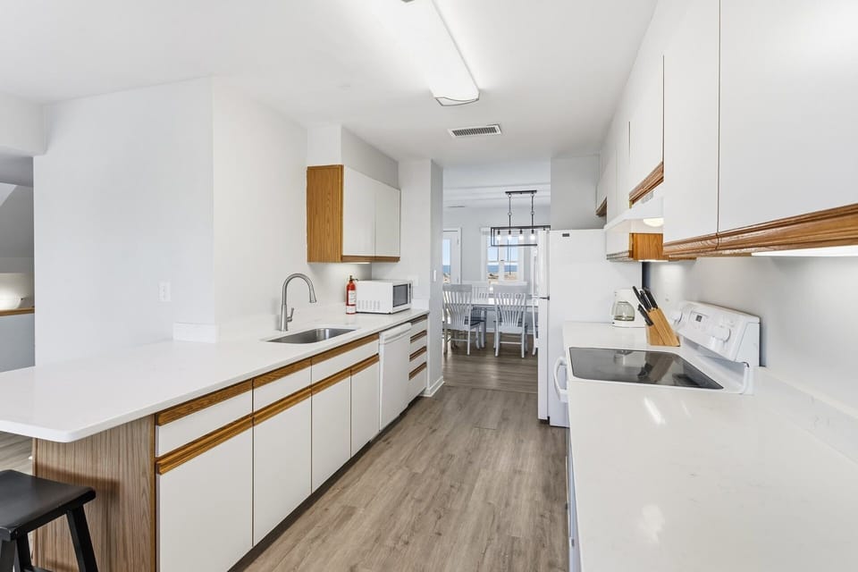 Cook with ease in the fully stocked kitchen featuring modern appliances, ample counter space, and a friendly open layout.
