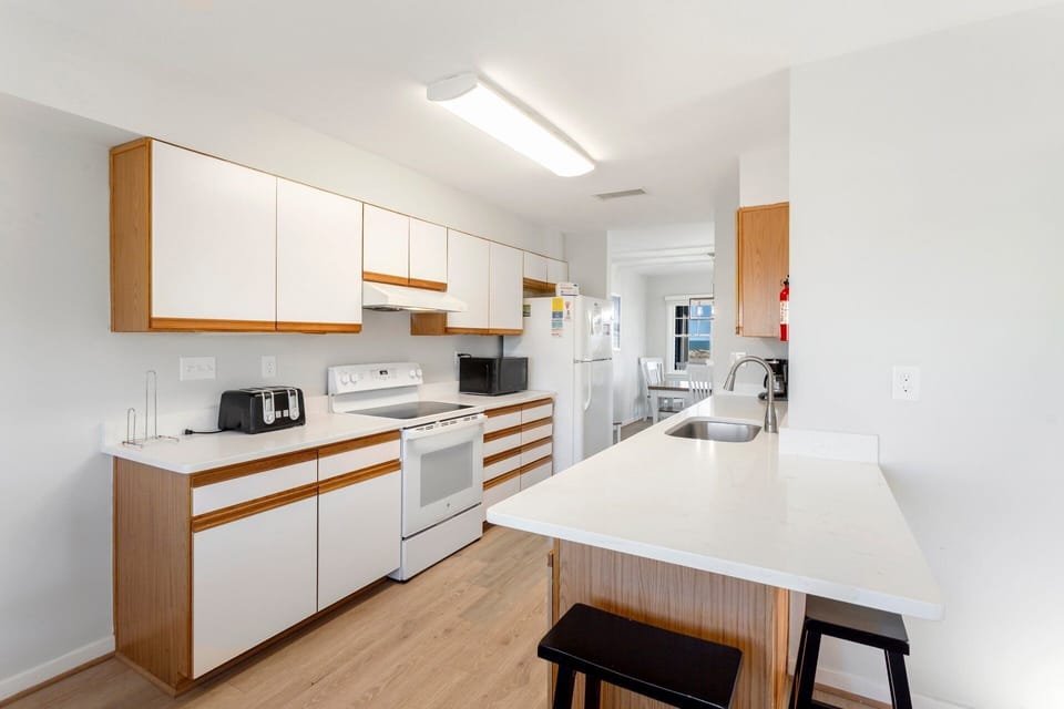 Cook up your favorite vacation dishes in the renovated kitchen with updated appliances, spacious countertops, and ample storage.
