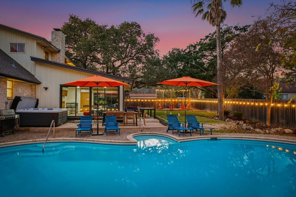 Backyard with heated pool, hot tub to the left, and putt-putt in the back.
