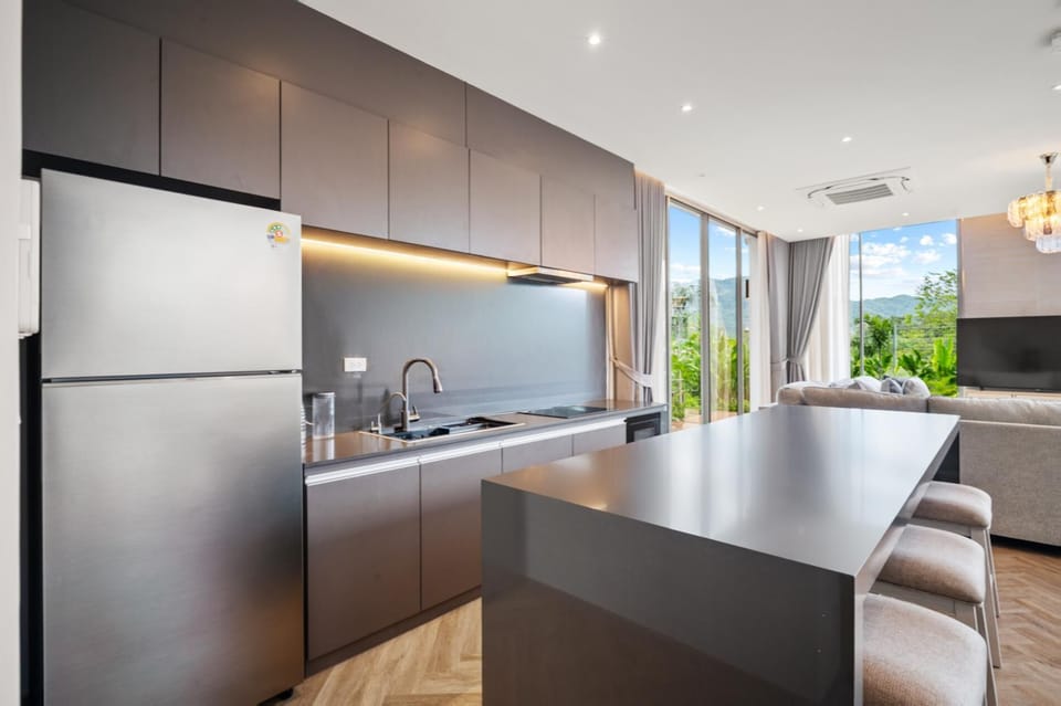 Spacious fully equipped kitchen with high-end appliances and a sleek modern design.