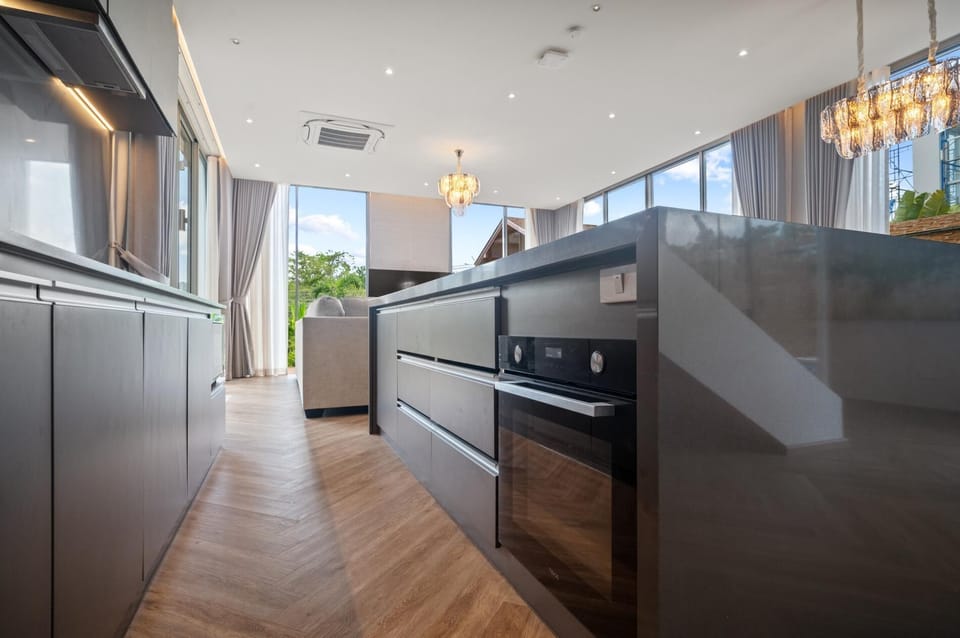Contemporary kitchen featuring ample counter space, built-in appliances, and natural light.