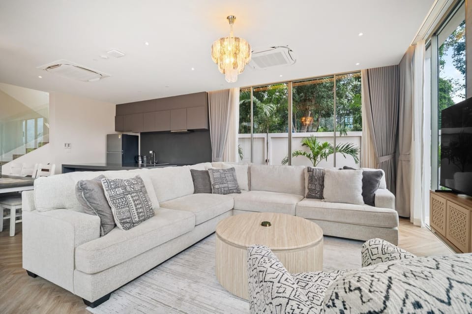 Spacious living and dining area with seamless indoor–outdoor flow and elegant neutral design