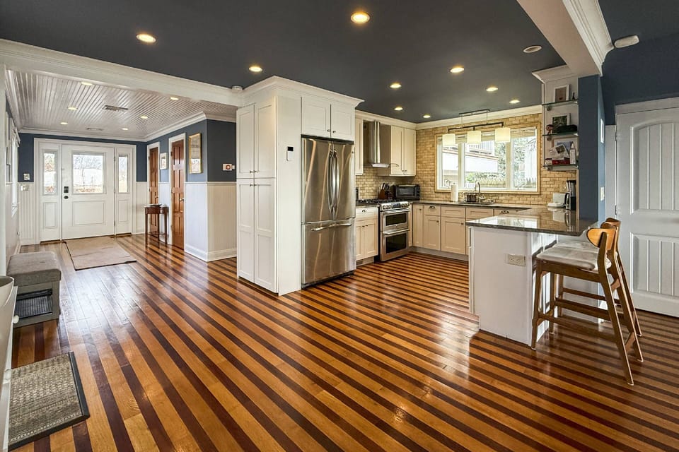 Welcoming, spacious entrance with convenient guest closet and stylish powder room nearby.