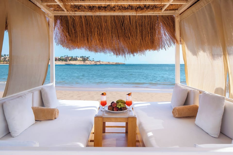 Relax in a private cabana facing the calm blue sea.